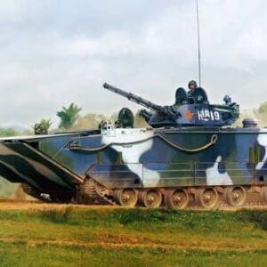 Military tank with mounted gun moving fast