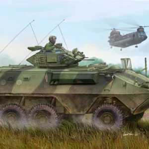 Military vehicle navigating through grassy terrain.