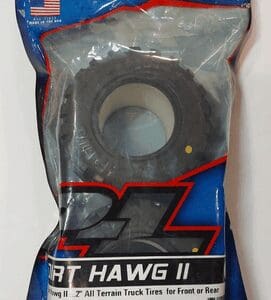 All-terrain truck tire in sealed packaging.